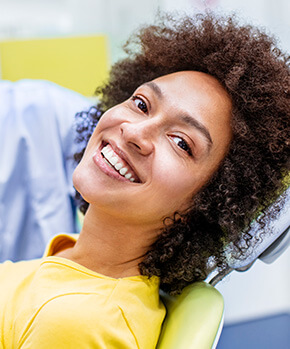 smiling woman sitting in a dental chair