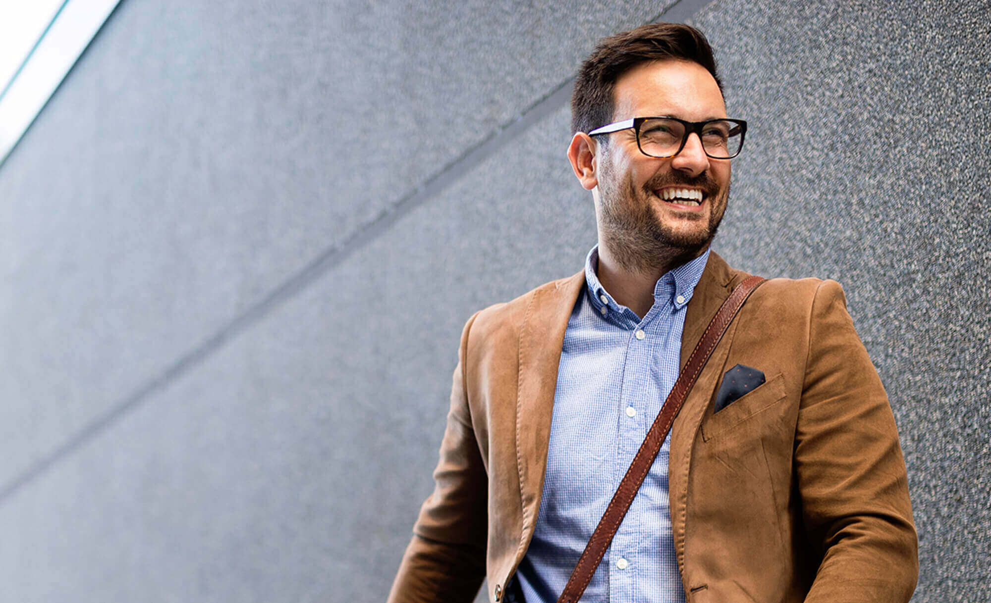 smiling man walking down the street