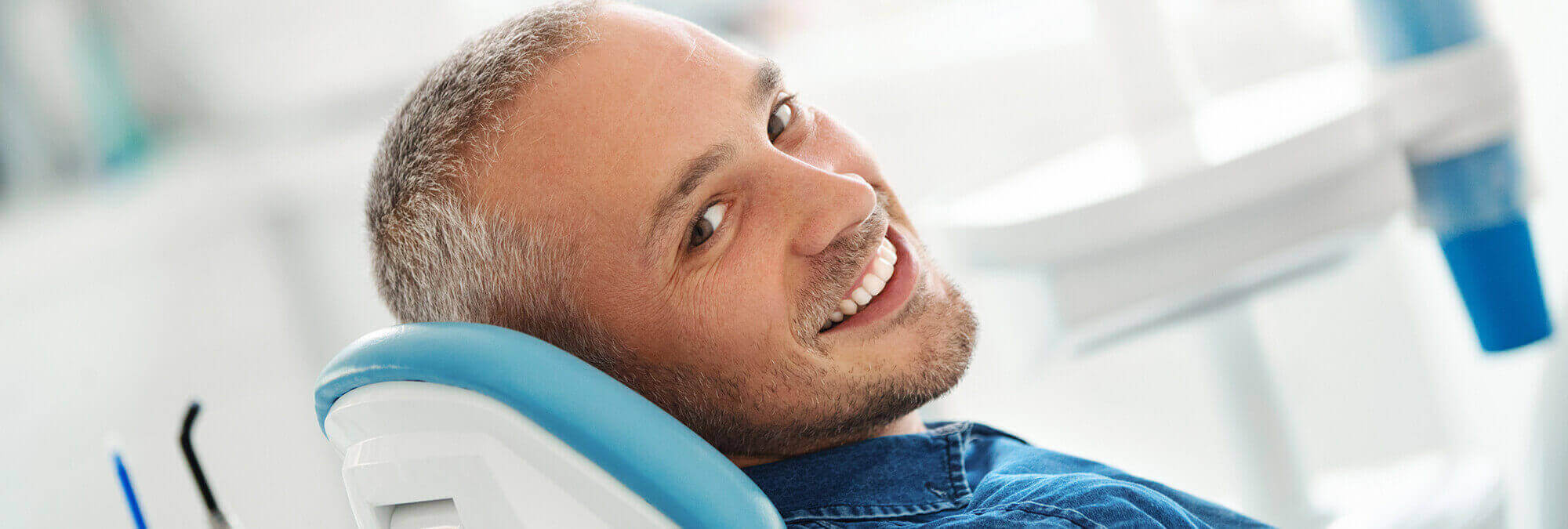 smiling man sitting in a dental chair