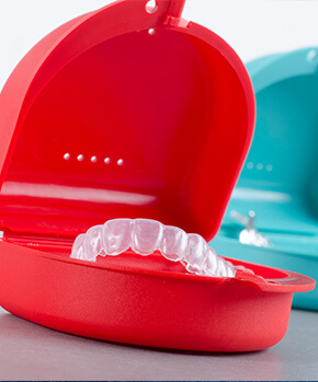 clear aligners sitting in their protective tray