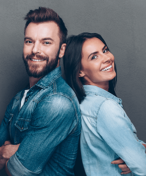 couple smiling and standing back to back