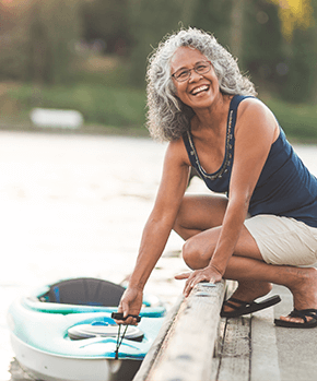 senoir woman holding kayak