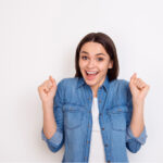 woman excited to learn about the options for dental veneers