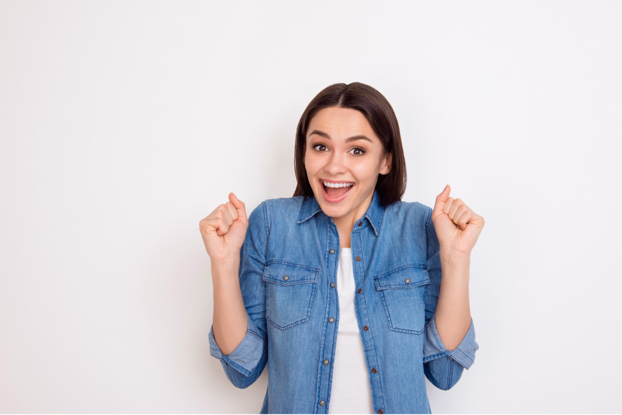 woman excited to learn about the options for dental veneers