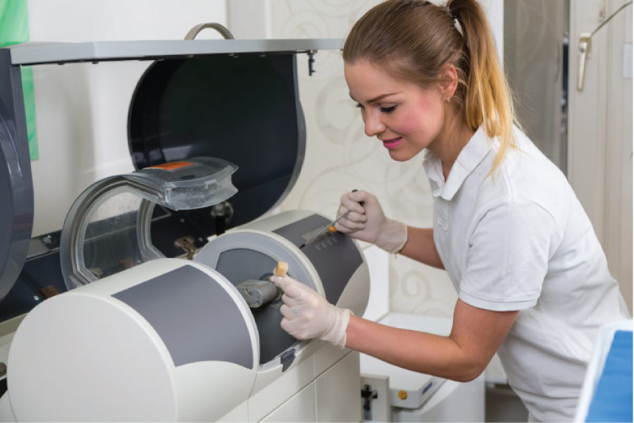 female dental technician uses the latest dental technology