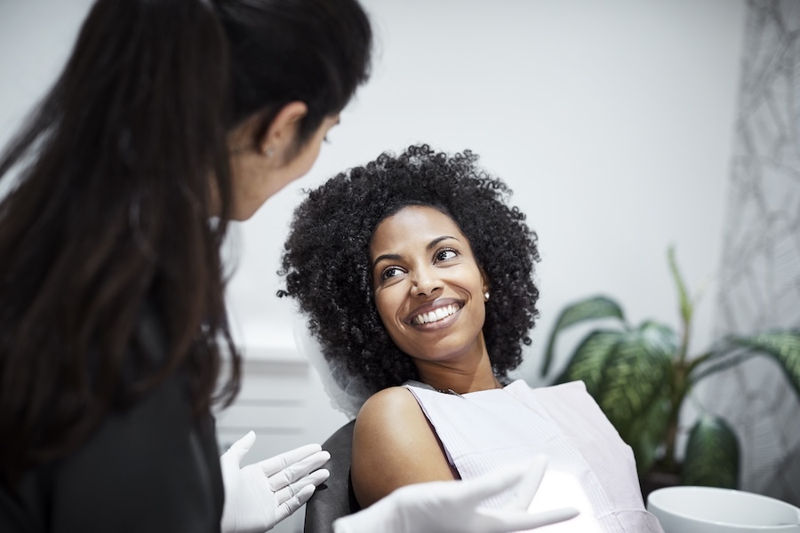 Black woman in dental chair for a dental cleaning