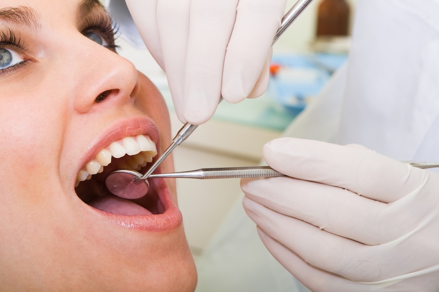oral cancer screening, woman in dental chair